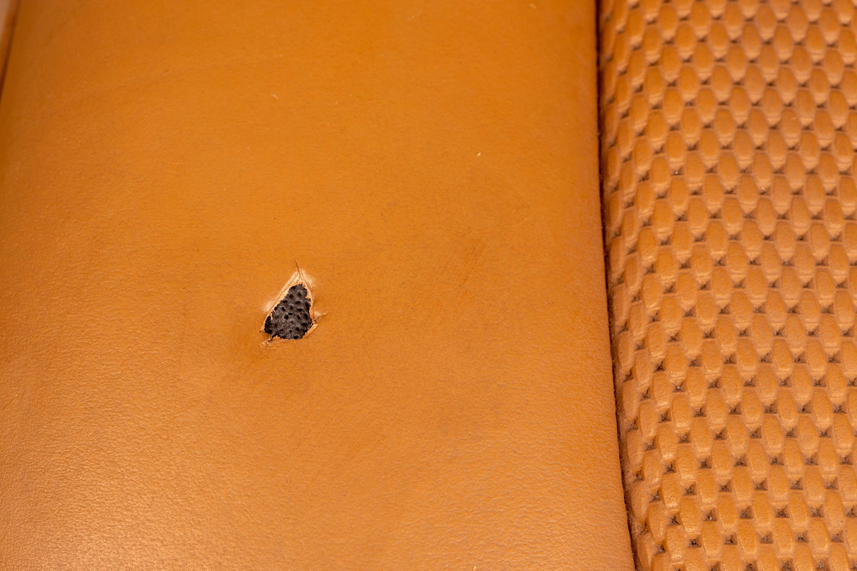 Detailing1 COLOURLOCK Fluid Leather — burn hole in a cognac perforated leather seat