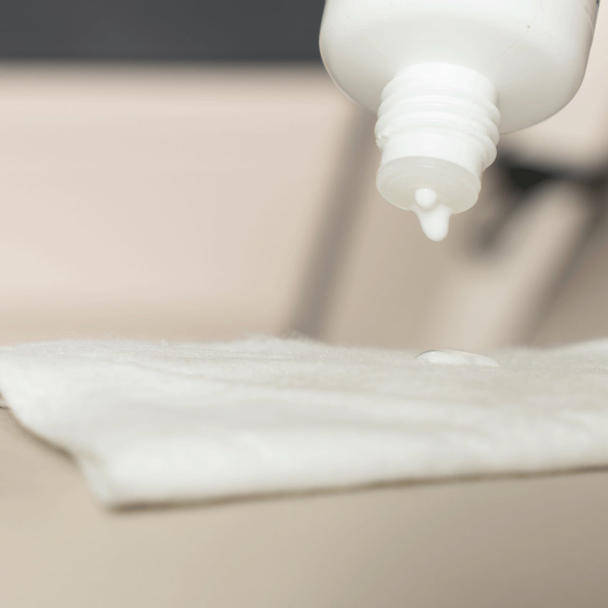 Detailing1 COLOURLOCK Lederversiegelung — Leather Shield tropft auf das Tuch, darunter helles Leder